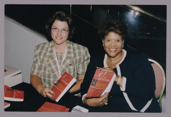 Frances Mitchelson and Patricia Russell-McCloud With Books at Convention Photograph, July 4-8, 2002 (image)