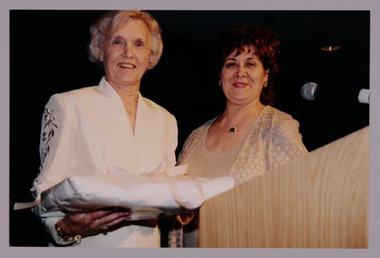 Annadell Lamb and Mary Jane Johnson With Gift at Carnation Banquet Photograph 1, July 4-8, 2002 (image)