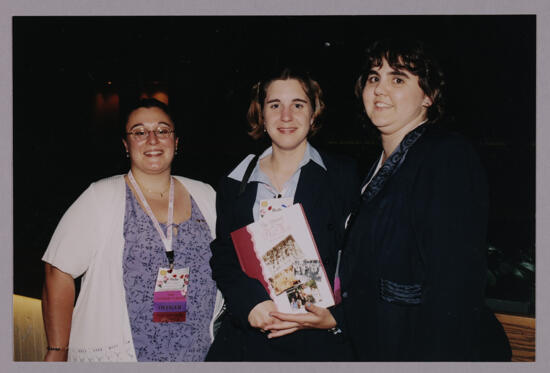 Julie, Beth, and Shelly with History Book at Convention Photograph, July 4-8, 2002 (image)