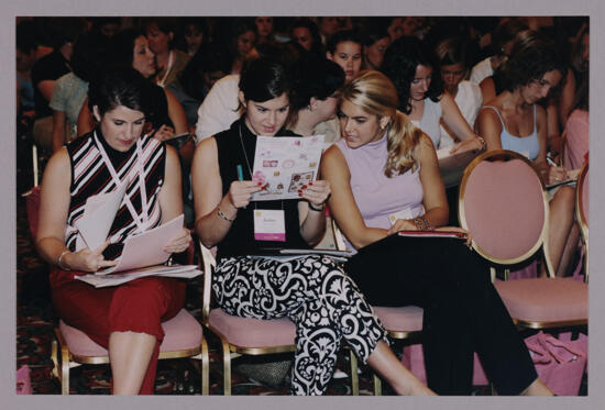 Collegiate Delegates Looking Over Convention Materials Photograph, July 4-8, 2002 (image)