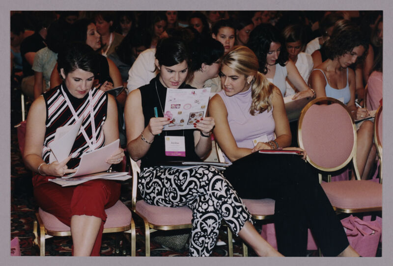 Collegiate Delegates Looking Over Convention Materials Photograph, July 4-8, 2002 (Image)