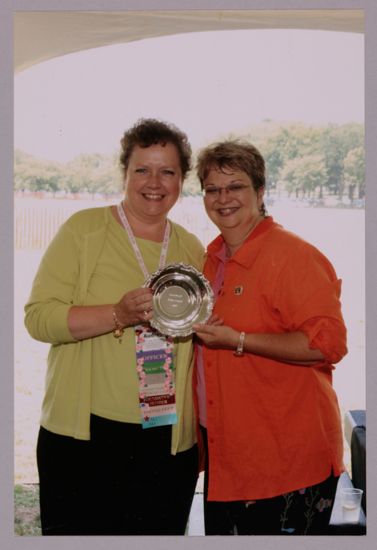 Audrey Jankucic and Kathy Williams With Award at Convention Outdoor Luncheon Photograph 1, July 10, 2004 (image)