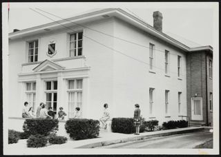 Beta Upsilon Members Outside Chapter House Photograph