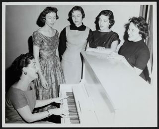 Gamma Pi Chapter Members Singing at Piano Photograph