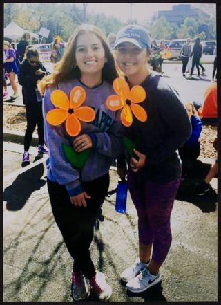 Two Xi Chapter Members Holding Orange End Alzheimer's Flowers Photograph 1, 2010s