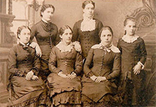 Carrie E. Allen (standing, far left) and Allen sisters