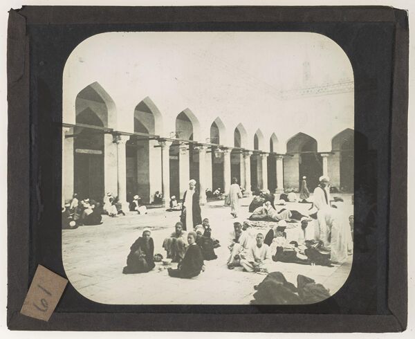 [Men setting in a mosque's courtyard]
