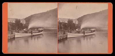 [Boat on river, mountain in the background]