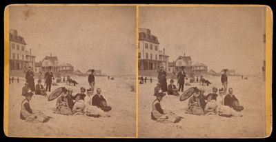 [Men and women sunbathing on sandy beach]