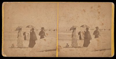 [Two women holding umbrellas conversing on beach]