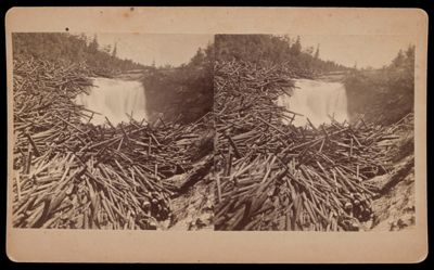 [Cluster of logs at the upper edge of a waterfall]