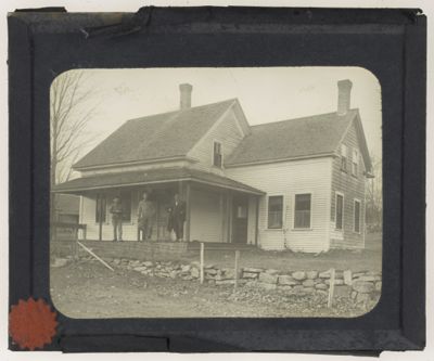 [Three men standing infront of home]
