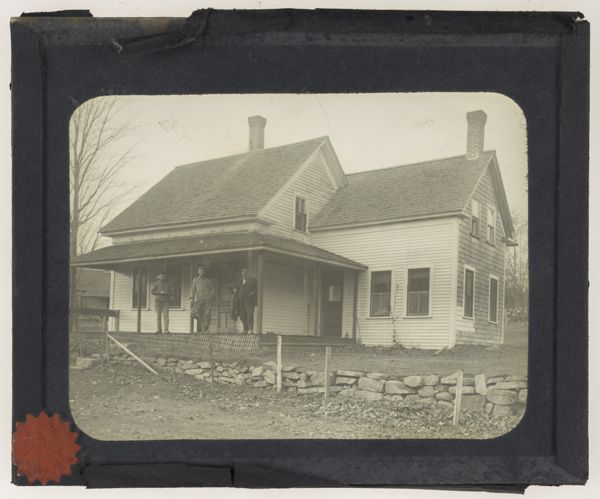 [Three men standing infront of home]