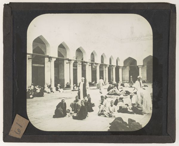 [Men setting in a mosque's courtyard]