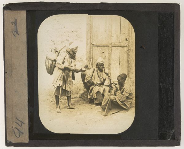 [Two men carrying water pots]
