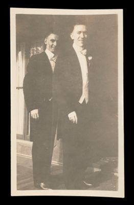 [Two Men Posing in Formal Attire]
