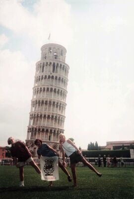 Members of Alpha Beta (Purdue University) and Gamma Mu (Ball State University) pose with an Alpha Chi Omega banner at the Leaning Tower of Pisa, ca 1990s, photograph