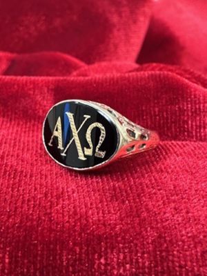 Silver ring with flat black stone and Greek letters