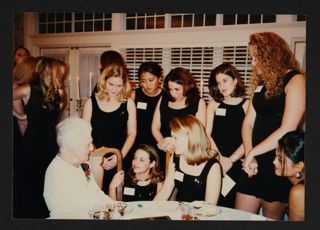 Collegians Around Alumna in White Dress Photograph, 1997