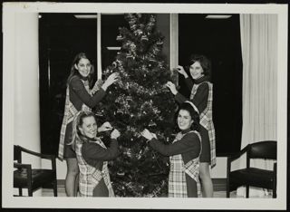 Cripe, Balaban, Cahill, and Barnes Decorating a Christmas Tree Photograph