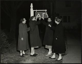 Gamma Iota Chapter Members Hanging a Delta Gamma Sign Photograph