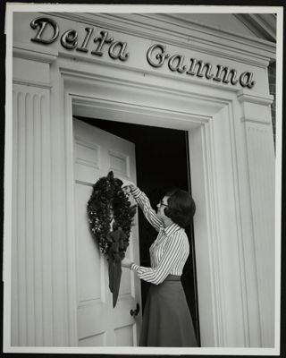 Carmalieta Brown Hanging a Wreath at the Executive Offices Photograph, 1972