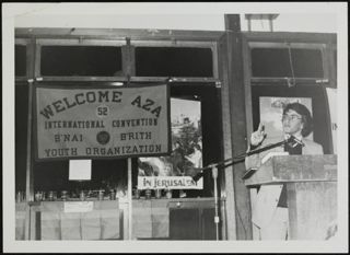 Man Speaking at Podium at Convention Photograph, 1975