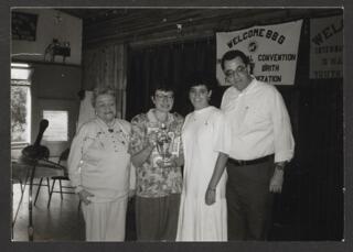 Anita Perlman and Three Unidentified People With Trophy Photograph, 1988