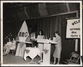 BBG Member Lighting a Menorah at Ceremony Photograph