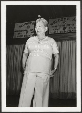 Anita Perlman on Stage With T-Shirt at Convention Photograph, 1979