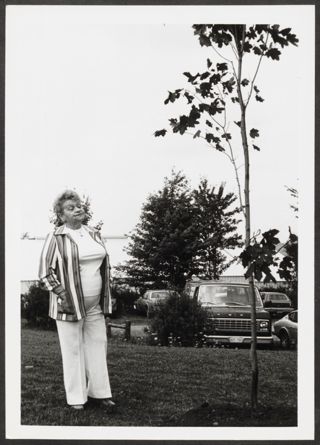 Anita Perlman Standing Outside Next to Tree Photograph 1, August 16-22, 1979