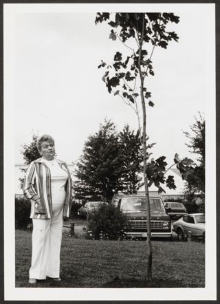 Anita Perlman Standing Outside Next to Tree Photograph 3, August 16-22, 1979