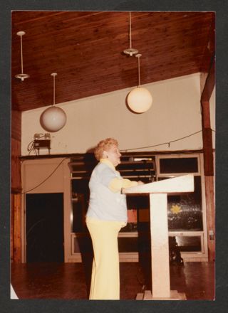 Anita Perlman Speaking at Podium Photograph, 1980s