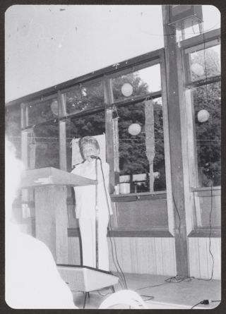 Anita Perlman Speaking at Meeting Postcard, September 1977