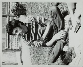 Unidentified Man Sitting in Grass Photograph