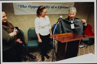 Lynn Schusterman Holding Sweater During Event Photograph