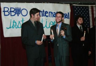 Three Members Holding Candles at Leadership Camp Photograph, July 12, 2006