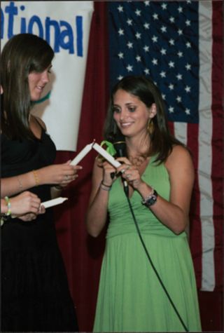 Two Members Lighting Candles at Leadership Camp Photograph 1, July 12, 2006