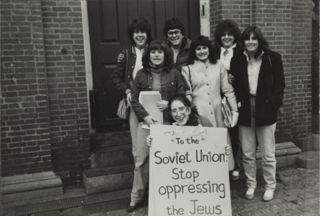 Melissa Hodes, Paul Lesser, and Other Members With Sign Photograph