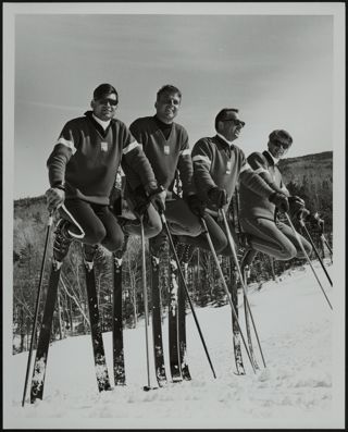 Four Ski Instructors Standing on Their Skis Photograph
