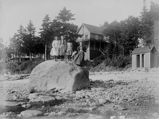 Four girls on big rock at Shady Nook, Trenton, Maine.