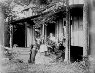 Group on rock by Foster cottage at Shady Nook, Trenton, Maine.