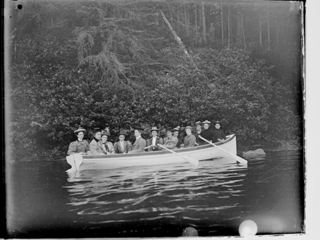 Twelve young women rowing close to Indian Point Shore, Union River, Ellsworth ME.