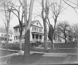 Parsonage from Mrs. Bailey's yard with Russell's delivery boy at steps and horse and delivery wagon in front