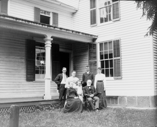 Same group before dining room doors with Ruth standing.
