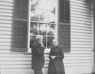 Father (finger on lips, side) and Mother under west window