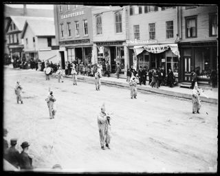 Circus parade clowns on foot playing musical instruments