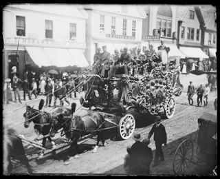 Horse-drawn circus wagon carrying musicians