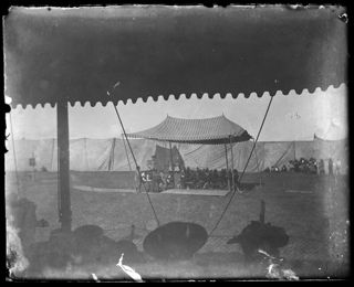Dramatic event possibly depicting Native Americans with a band playing under a tent