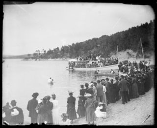 Baptism in Green Lake with onlookers from <i>The Senator</i> and other boats